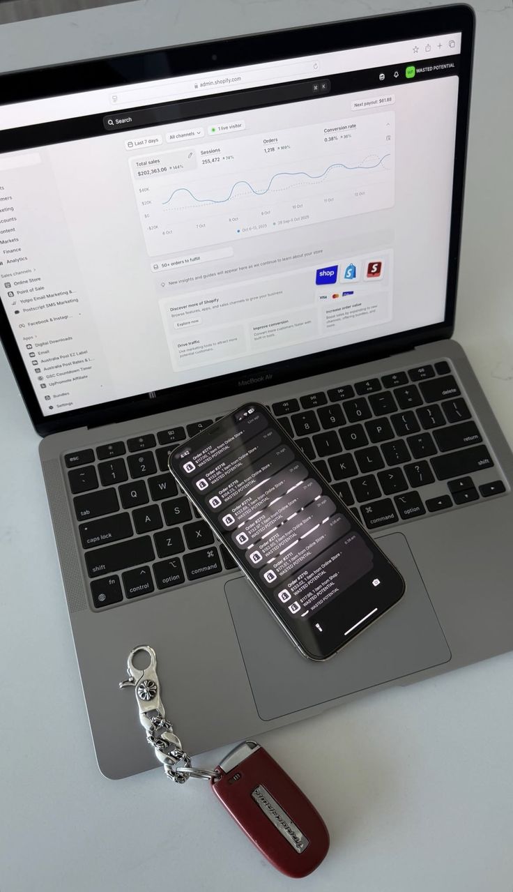 Commerce dashboard on a laptop with store notifications on a phone